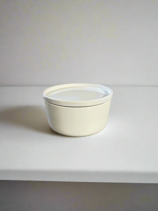 Mini fireplace candle sitting on a shelf.